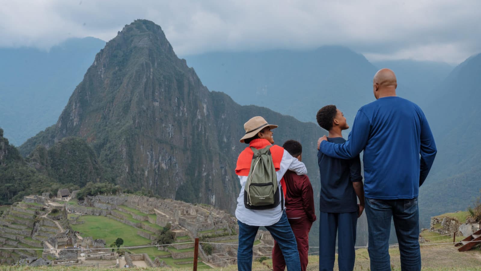 family at Machu Picchu on an Adventures by Disney tour looking out at the ruins