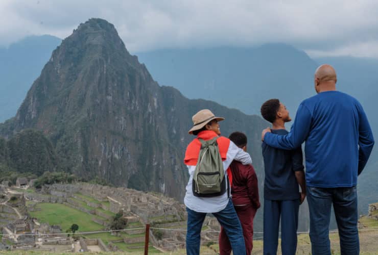 family at Machu Picchu on an Adventures by Disney tour looking out at the ruins