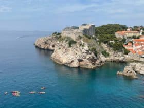 Adventures by Disney Adriatic Expedition Cruise in Dubrovnik kayaks in the shadow of a fortress