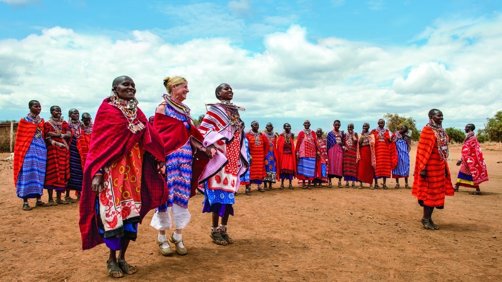 O.A.T. tour guest participating in a ceremony at a Maasai village in Kenya on an Overseas Adventure Tour