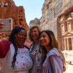 women on an Intrepid Tours women-only tour taking a selfie at Petra in Jordan