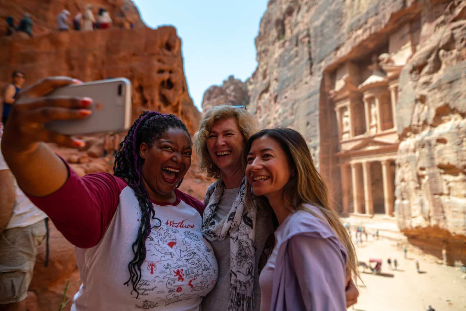 women on an Intrepid Tours women-only tour taking a selfie at Petra in Jordan