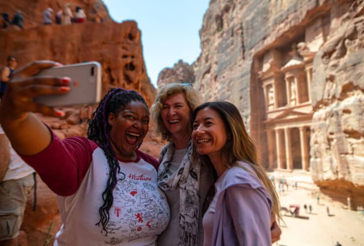 women on an Intrepid Tours women-only tour taking a selfie at Petra in Jordan