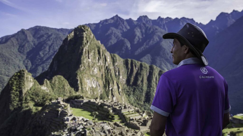 G Adventures guide looking out over Machu Picchu on a hiking tour in Peru