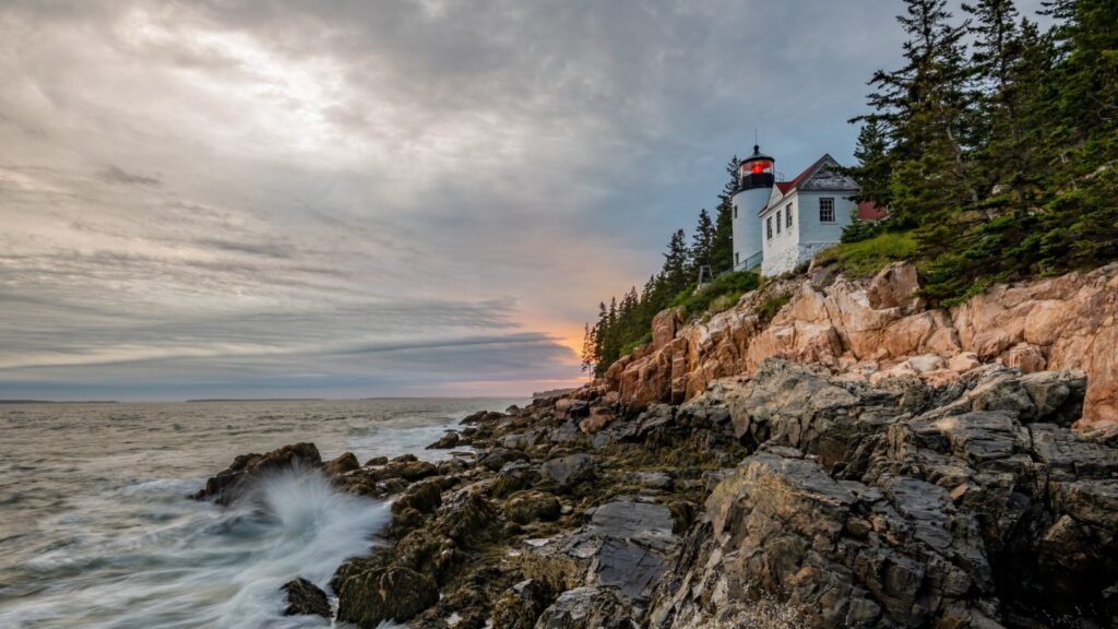 Bass Harbor Lighthouse in Acadia National Park with ocean in foreground