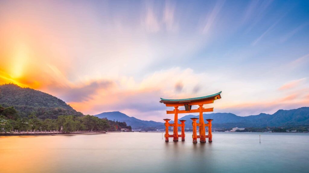 Sunrise or sunset at Miyajima, Hiroshima, Japan at Itsukushima Shrine.