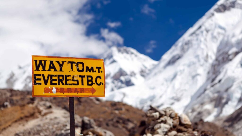 Travel to Mount Everest Base Camp signpost in Himalayas, Nepal. Khumbu glacier and valley snow on mountain peaks, beautiful view landscape