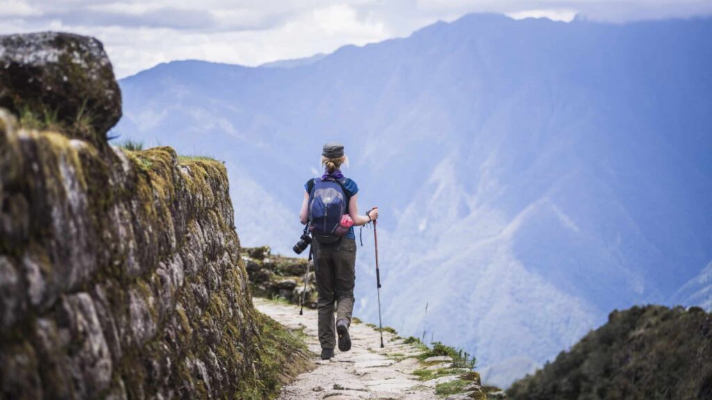 person on a hiking tour of the Inca trail trek with Andes mountains in background