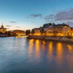 Paris and the Seine River at dawn with reflections from lights on the river