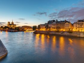 Paris and the Seine River at dawn with reflections from lights on the river