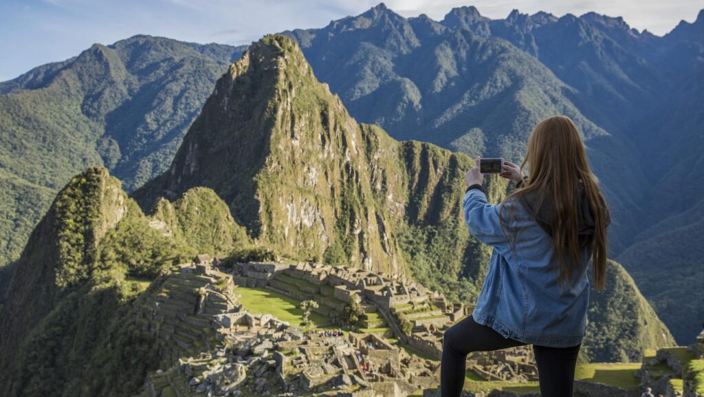solo traveler taking a photo at Machu Picchu