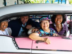 Road Scholar participants in an antique car in Havana on a Cuba tour