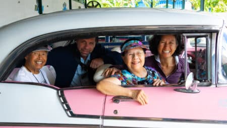 Road Scholar participants in an antique car in Havana on a Cuba tour