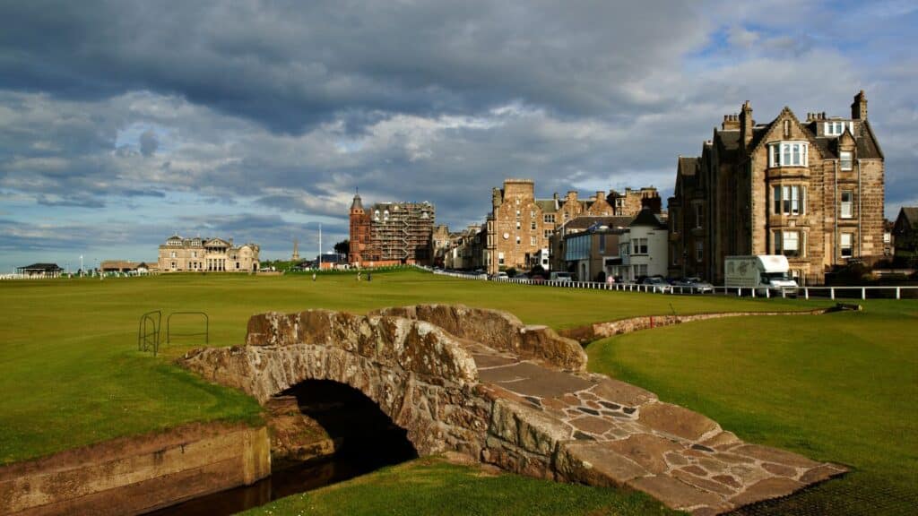 view of bridge and green hill in St. Andrews, Scotland