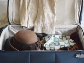 partially packed suitcase with hat