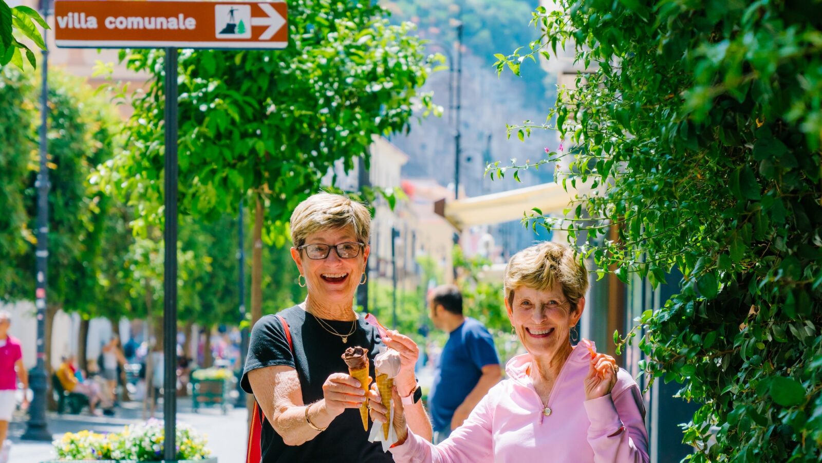 two women eating gelato on a streetcorner in Sorrento