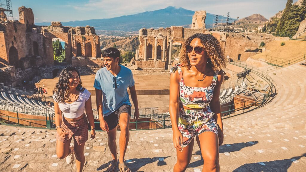 Young people at ruins in Sicily on a Contiki tour