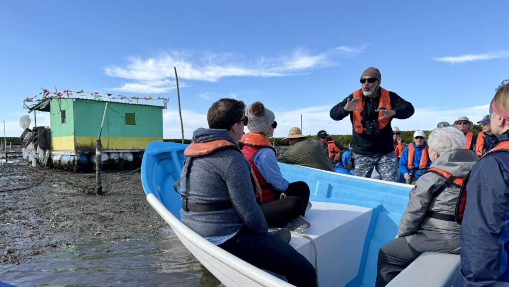 tour guide on a Lindblad Expeditions National Geographic Baja California tour explaining oyster farming to tour guests