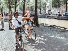 young people on bicycles riding around a European city on a Contiki tour