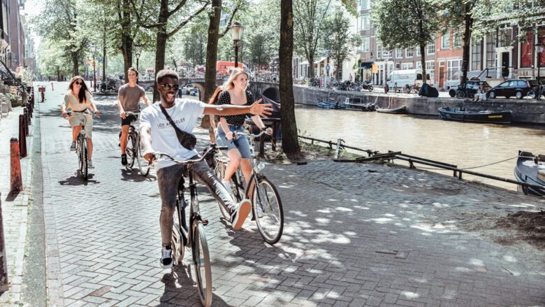 young people on bicycles riding around a European city on a Contiki tour