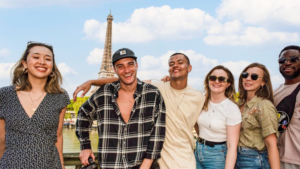 Young people on a Contiki tour in front of the Eiffel Tower in Paris