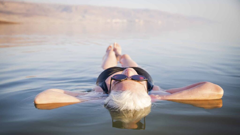 Woman floating in the Dead Sea on a G Adventures tour of Jordan