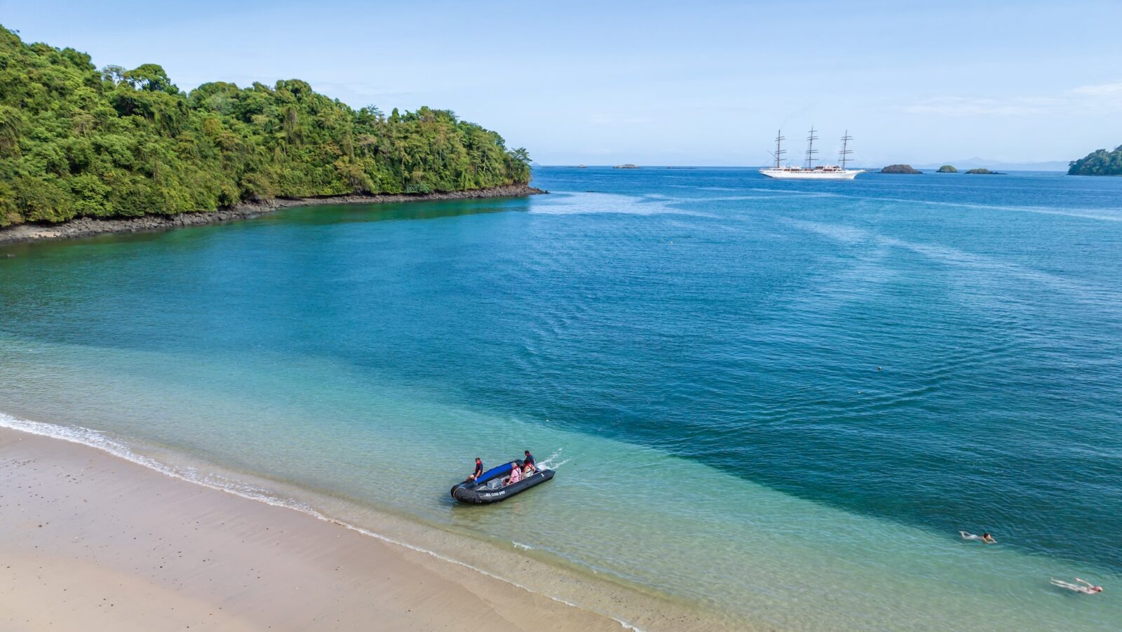 zodiac landing on quiet beach with azure water in Panama's Coiba National Park on a SeaCloud cruise