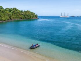zodiac landing on quiet beach with azure water in Panama's Coiba National Park on a SeaCloud cruise
