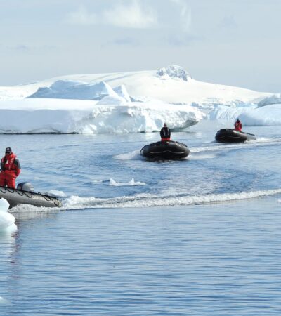 Smithsonian Journeys and Ponant zodiacs driving through icebergs