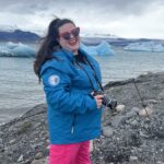 Megan in Iceland with icebergs behind her