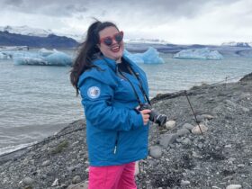 Megan in Iceland with icebergs behind her