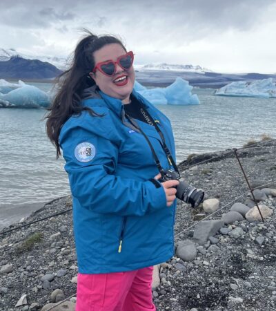 Megan in Iceland with icebergs behind her