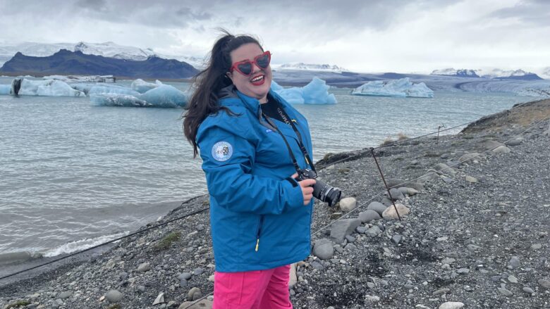 Megan in Iceland with icebergs behind her