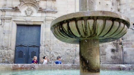 kids running behind fountain in the Barrio Gotico in Barcelona, Spain