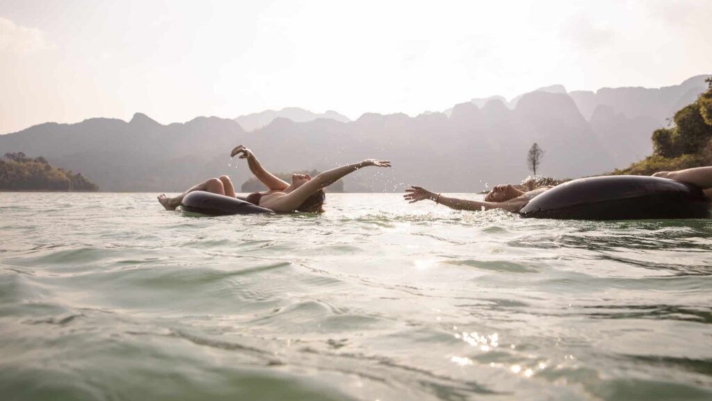 G Adventures young tour guests at Khao Sok National Park tubing in the water