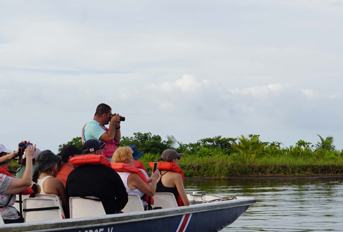 Costa Rica tour guide VIctor Leiton taking photos on a boat ride with tour group in Tortuguero National Park