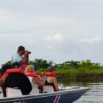 Costa Rica tour guide VIctor Leiton taking photos on a boat ride with tour group in Tortuguero National Park