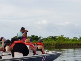 Costa Rica tour guide VIctor Leiton taking photos on a boat ride with tour group in Tortuguero National Park