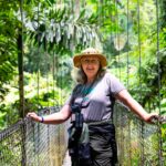 A woman standing on a rope bridge at the Arenal Volcano in Costa Rica on a Road Scholar tour