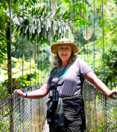 A woman standing on a rope bridge at the Arenal Volcano in Costa Rica on a Road Scholar tour