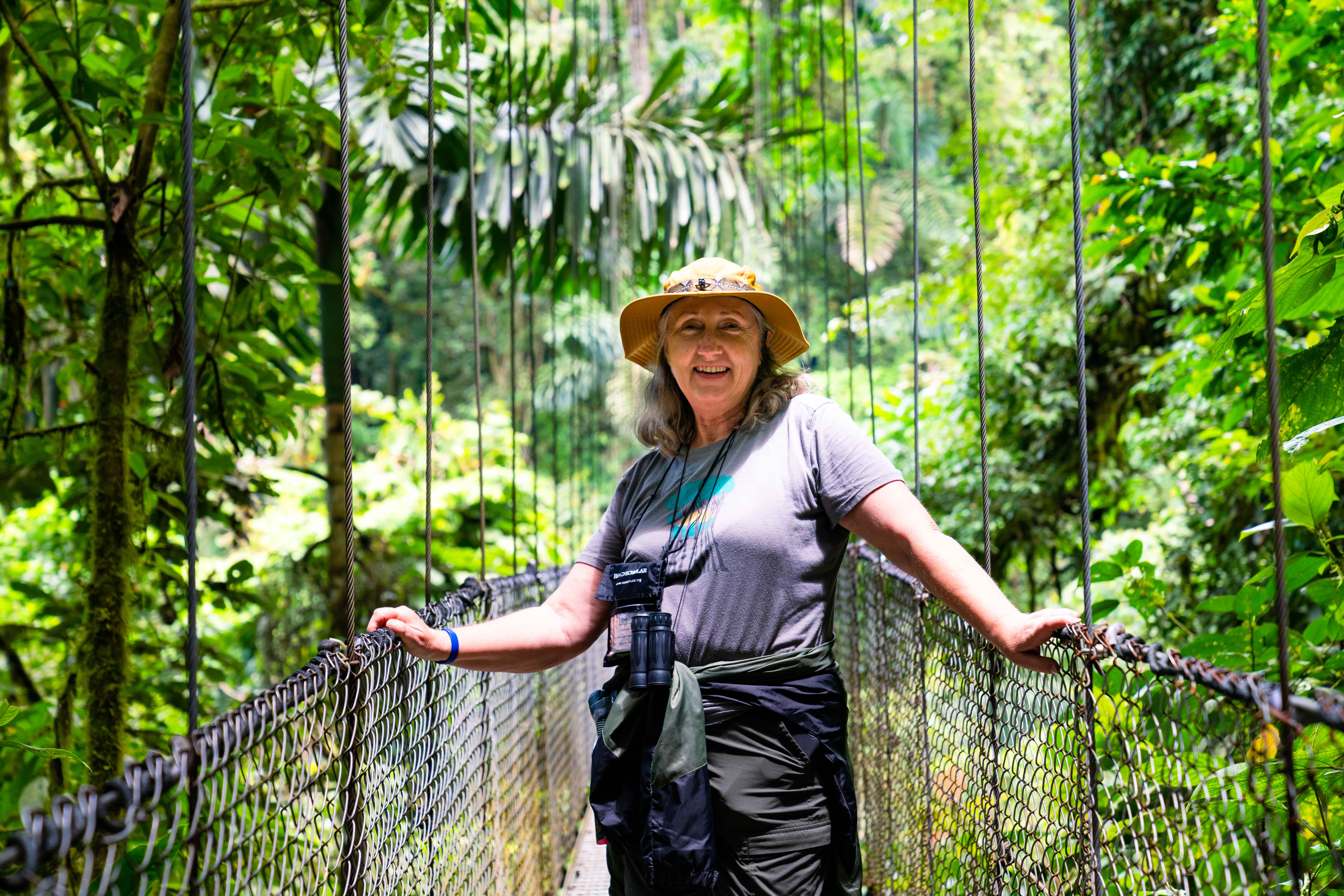 A woman standing on a rope bridge at the Arenal Volcano in Costa Rica on a Road Scholar tour