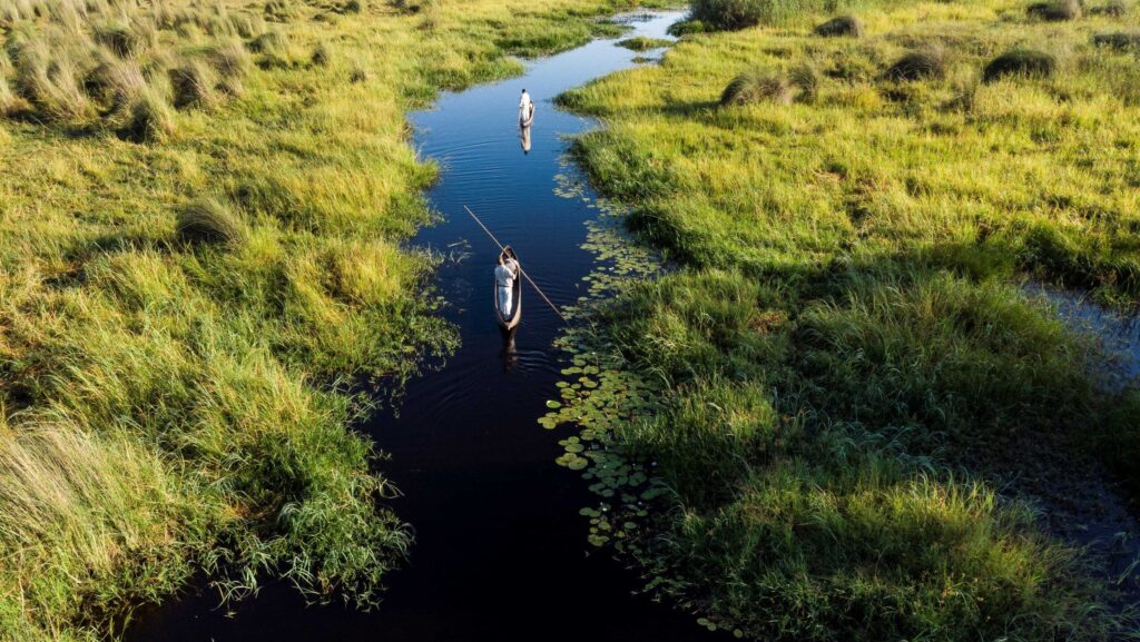 Two small watercraft in a waterway during an Abercrombie & Kent excursion to Stanley’s Camp, Moremi Game Reserve, Okavango Delta, Botswana