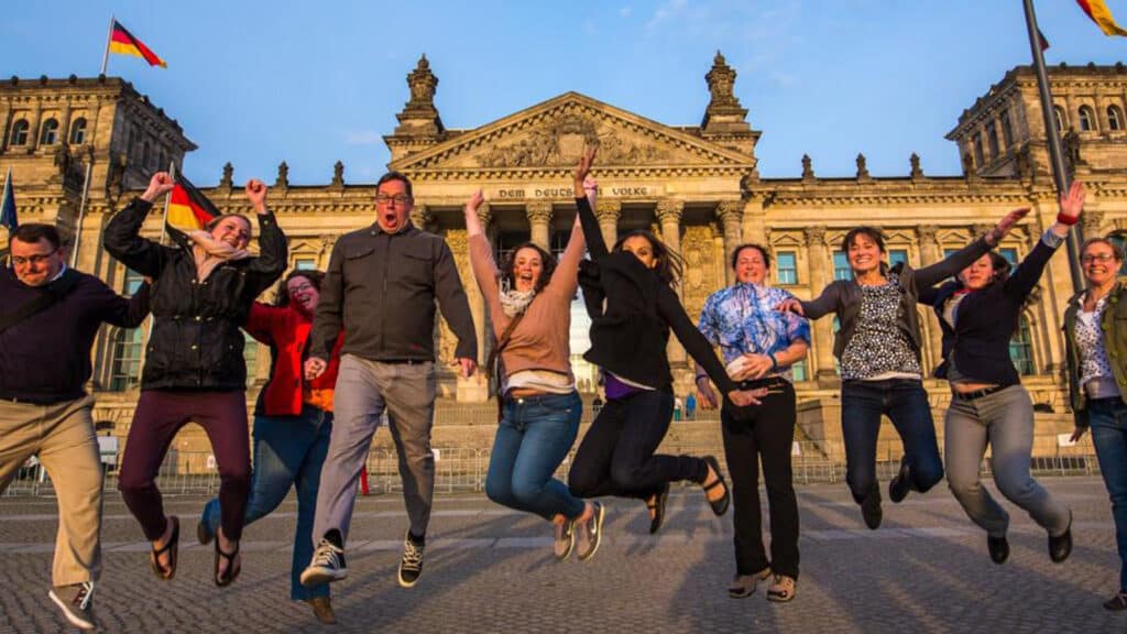 Students jumping in front of an old building in Germany