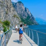 Tourgoers riding bikes along Italy's Lake Garda