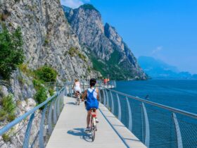 Tourgoers riding bikes along Italy's Lake Garda