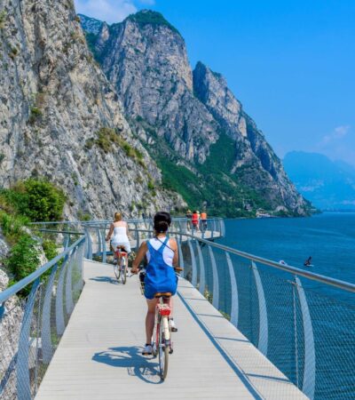 Tourgoers riding bikes along Italy's Lake Garda