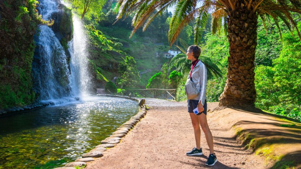 A woman on a path looking at a small waterfall on a Road Scholar tour in Portugal