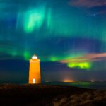 Lighthouse on Reykjanes peninsula under the aurora borealis in Iceland.