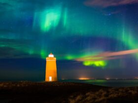 Lighthouse on Reykjanes peninsula under the aurora borealis in Iceland.