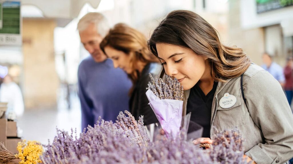 Woman smelling flowers at a market